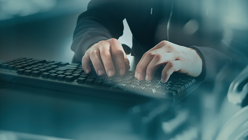 Man typing on computer keyboard