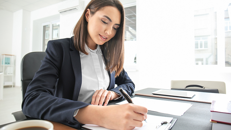 Business woman signing documents